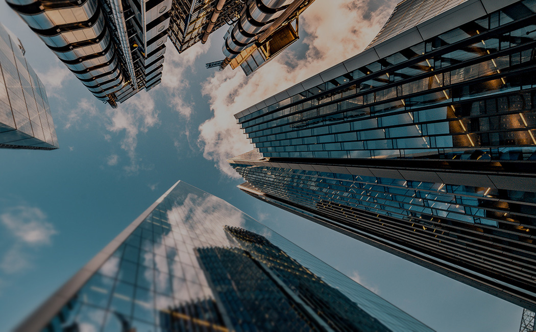 tall buildings reaching into sky in a city, Banking & Capital Markets  | DXC Technology