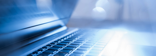 Laptop with sun on the keyboard, Global insurer boosts innovation, simplifies operations | DXC Technology Customer Stories